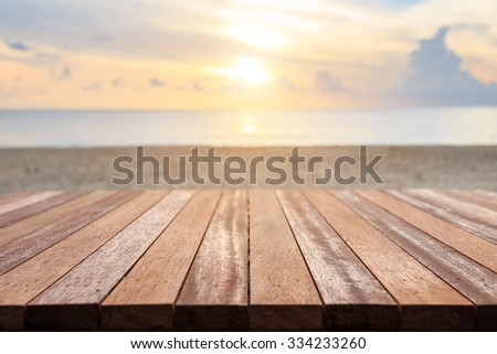 Close up top of wooden table at sunset beach. Can use for product display