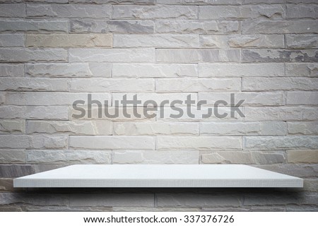 Empty top wooden shelves and stone wall background. For product display