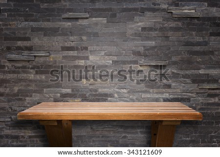 Empty top wooden shelves and stone wall background. For product display