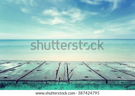 Empty top of wooden table and view of tropical beach background. For product display