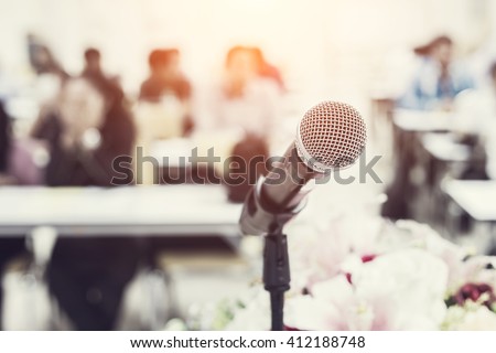 Close up microphone on the desk in meeting room with blur people background, Vintage filter effect
