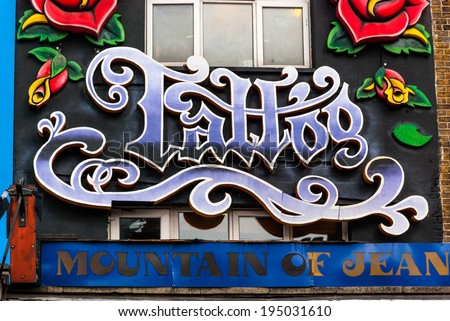 Tattoo sign on a brick wall. London, United Kingdom - October 2, 2013: Old tattoo shop in London.