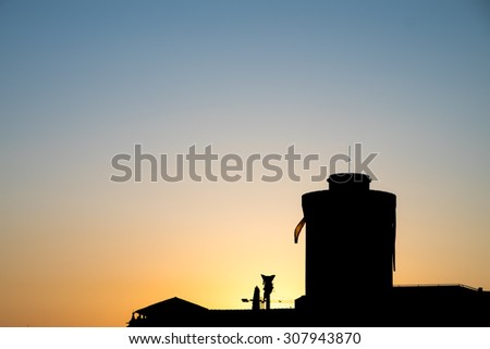 The harbor with a lighthouse at sunrise in Livorno, Tuscany, Italy.