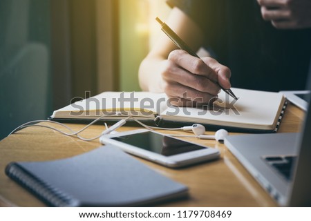 high school,college,university student using laptop searching information from network.people writing on notebook in modern library concept for scholarship to research international education learning