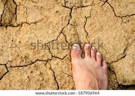 Naked Feet on dry Soil