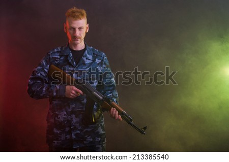 Man in camouflage clothing with a gun