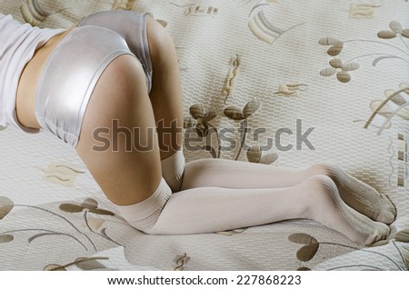 Sexy girl kneeling on bed