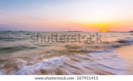 Seascape on sunset background focus on the sky and land silhouette