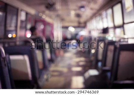 Abstract background blur people on the bus at night in Thailand. The last bus at night waiting for last passenger to go with them. Vintage tone
