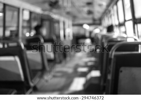 Abstract background blur people on the bus at night in Thailand. The last bus at night waiting for last passenger to go with them. Black and White tone