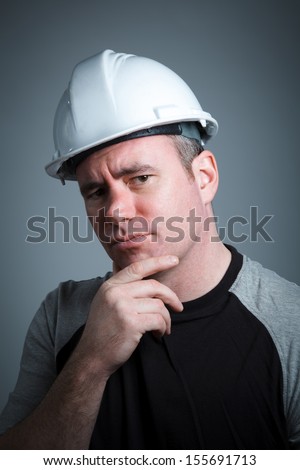 Caucasian contractor male 40 years old shot in studio isolated on grey background