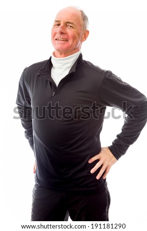 Senior man standing with arms akimbo and smiling
