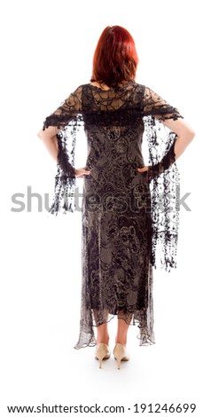 Rear view of a mature woman standing with her arms akimbo
