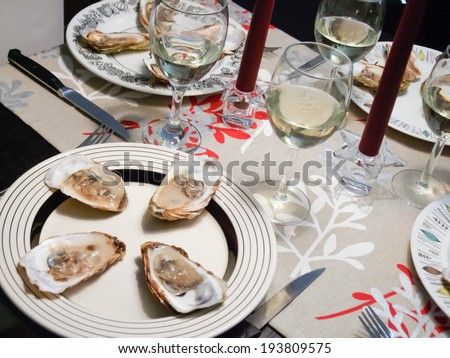 Oysters and white wine served in candlelight dinner