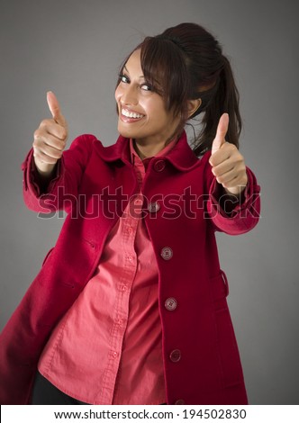 Indian young woman making thumbs up sign from both hands