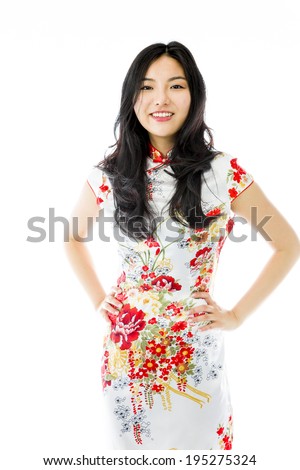 Confident Asian young woman standing with arms akimbo