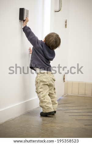 Boy using a card key to open a door