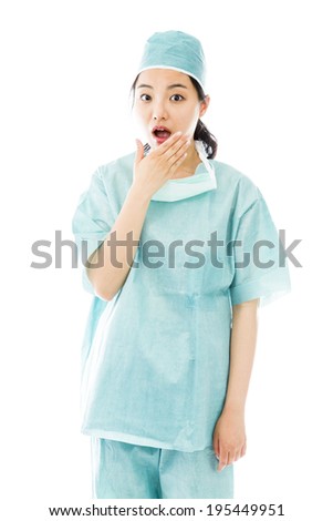 Shocked Asian female surgeon with hand over mouth isolated on white background