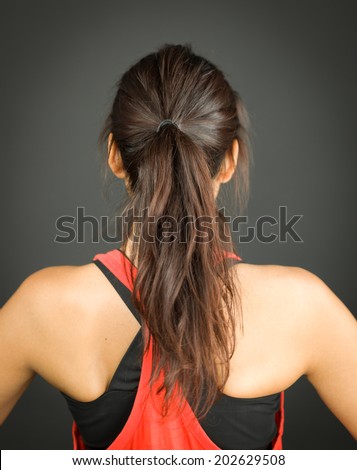 Rear view of a young woman with ponytail