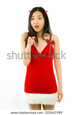 Devil side of a young Asian woman pointing and looking shocked isolated on white background