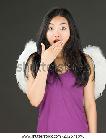 Angel side of a young Asian woman looking shocked