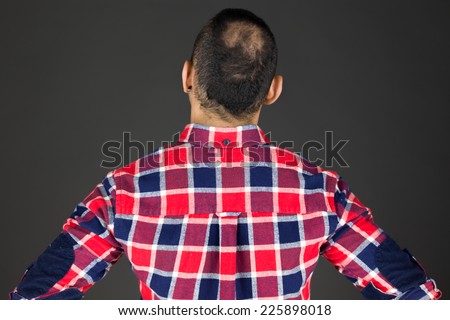 model isolated on plain background back hands on hips