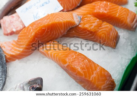 Display of frozen salmon slices for sale at a market stall, La Boqueria Market, Barcelona, Catalonia, Spain