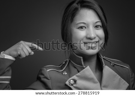 Model isolated on plain background in studio pointing