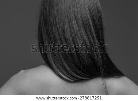 Model isolated on plain background in studio from behind