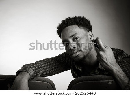 Attractive afro-american man posing in a  studio isolated on a background, black and white image