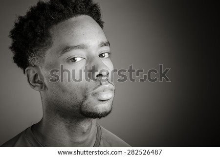 Attractive afro-american man posing in a  studio isolated on a background, black and white image