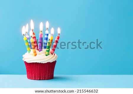 Birthday cupcake against a blue background