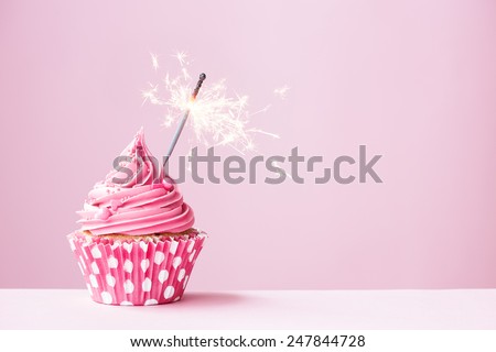 Pink cupcake decorated with a sparkler