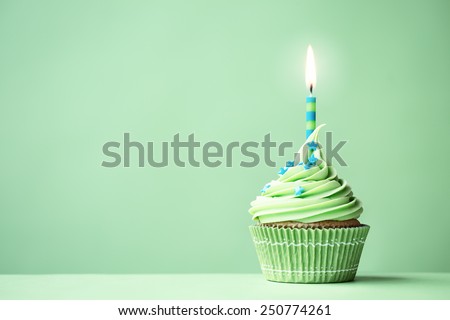 Green birthday cupcake with copy space to side