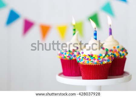 Colorful birthday cupcakes on a cake stand