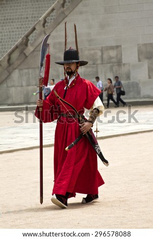 SEOUL, KOREA - MAY 17, 2015:  Armed guards in traditional costume guard the gate at Gyeongbokgung Palace a tourist landmark, in Seoul, South Korea on May 17, 2015
