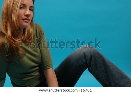 Relaxed shot of a beautiful, thin model in green top and jeans