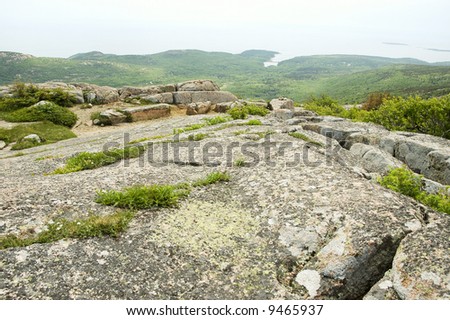 granite rocks and view from Cadillac Mountain of Atlantic coastal islands in Acadia National Park