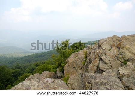 rolling green mountains from a rock peak in summer