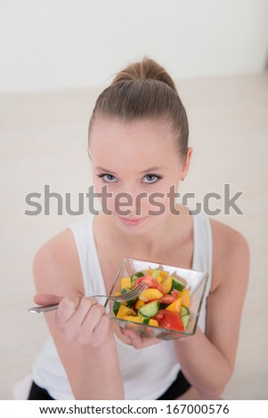 Portrait of sport woman eating vegetables