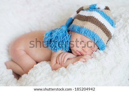 Newborn baby  peacefully sleeping in cap
