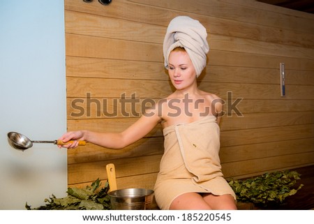 Beautiful young woman relaxing in a finish sauna