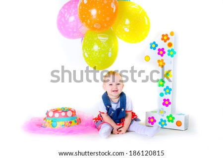 Little beautiful kid celebrate her first birthday  with cake among balloons isolated on white