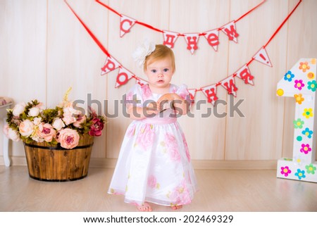 Little cute kid girl celebrate first Happy Birthday Party with  decor in the beautiful room