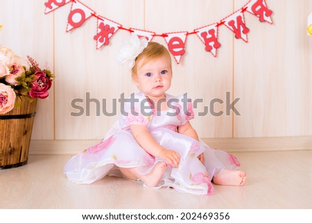 Little girl celebrate first Happy Birthday Party with  decor in the beautiful room fun game