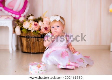 Little girl child celebrate first Happy Birthday Party with  decor in the beautiful room