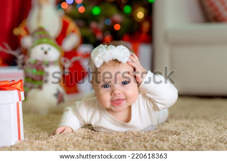 New Year\'s Concept. Adorable cute little girl near a Christmas tree with presents. new year