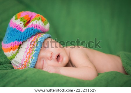 sleeping child in bright knitted cap