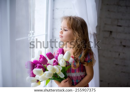 child with flowers in the window