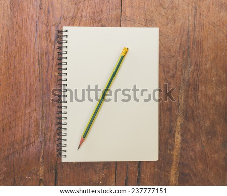 book and pencil on wood table